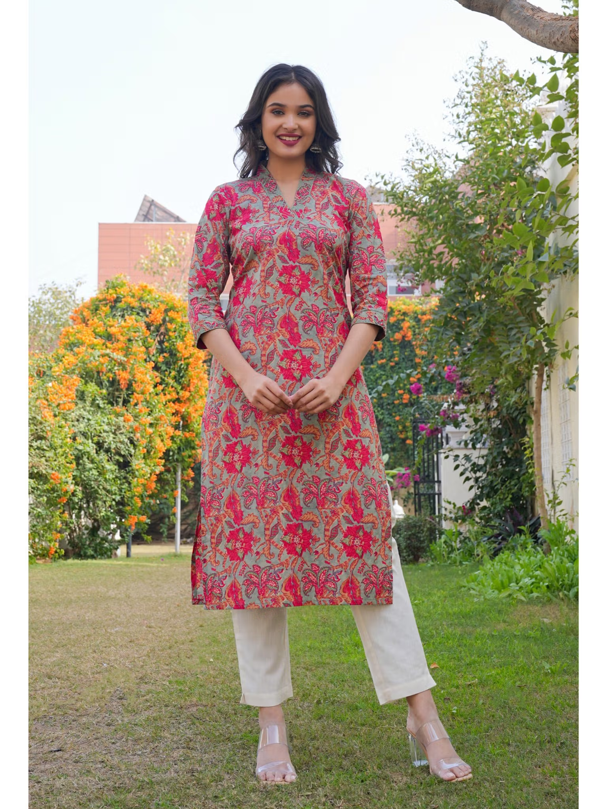 aromie single piece pink and red floral embroidered kurta on model in garden setting Embroidered jumpsuit for women