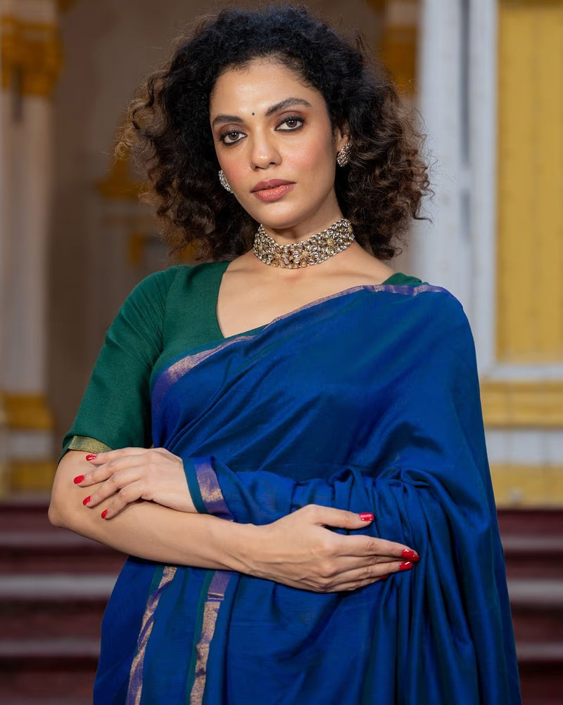 Elegant woman in Bandhani Silk Saree Online with rich blue color, featuring a stylish blouse and accessories