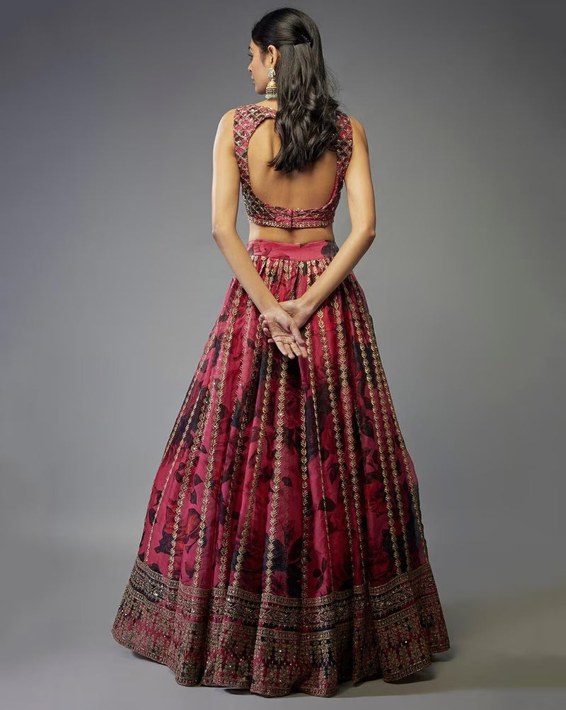 Back view of model in maroon embroidered lehenga choli set Canada with open back blouse and ornate skirt border