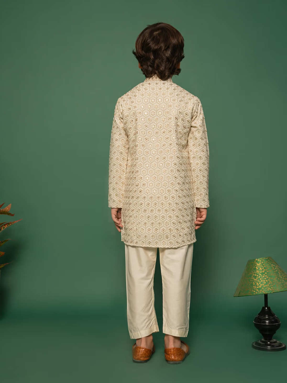 Rear view of boy wearing boys off white kurta pyjama set Canada patterned long kurta and straight pyjama pants