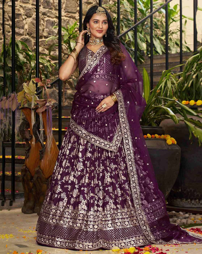 Model wearing deep purple embroidered lehenga choli set Canada with silver floral embroidery and sheer dupatta