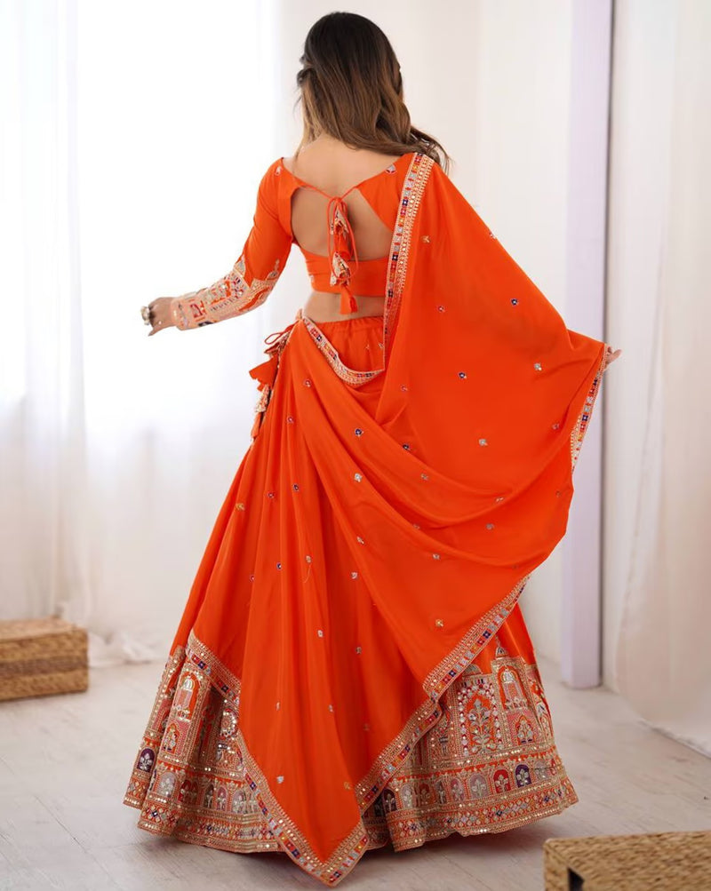 Orange embroidered lehenga choli set Canada with open back blouse tie and mirror work and ornate border