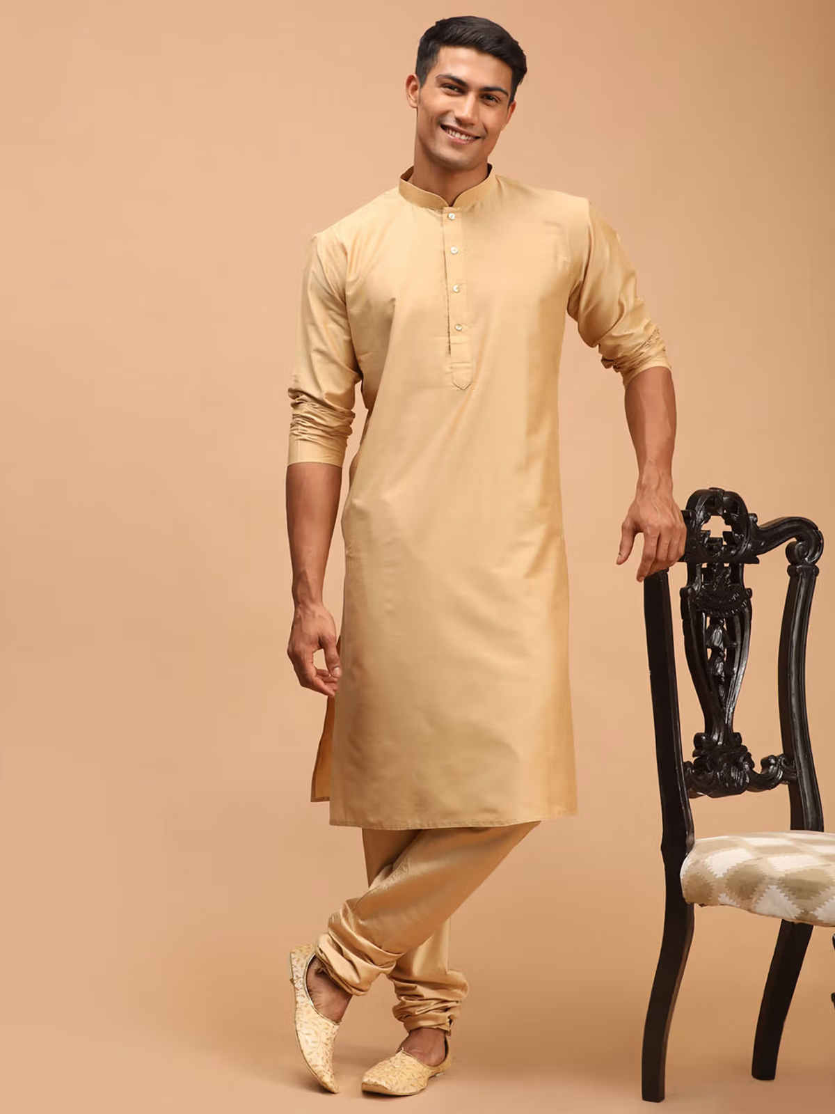 mens beige viscose kurta with mandarin collar and full sleeves paired with churidar and traditional shoes
