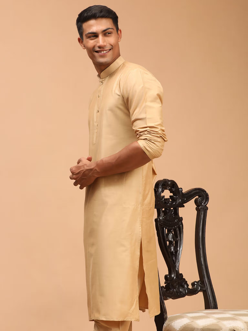 Smiling model wearing mens beige viscose kurta with mandarin collar side slits and rolled sleeves by AROMIE