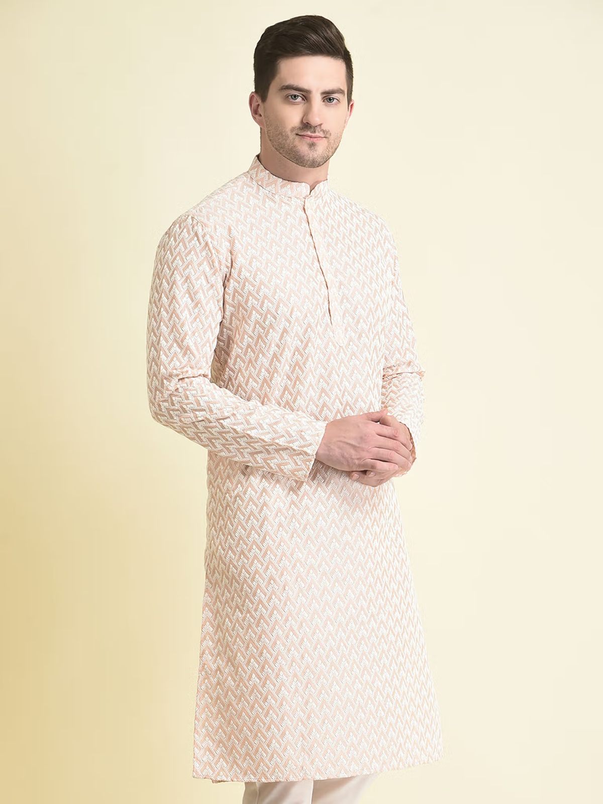 Male model wearing men's pink chikankari kurta with mandarin collar full sleeves knee length straight fit