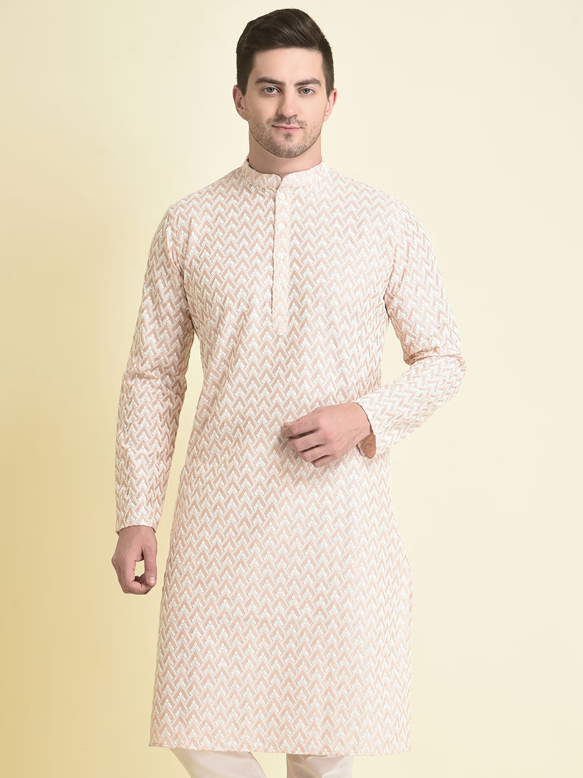 Model wearing men's pink chikankari kurta with mandarin collar and subtle embroidered chevron design