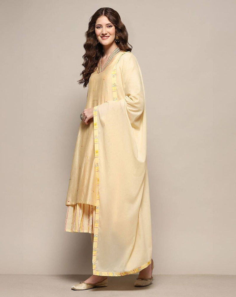 Aromie three piece floral embroidered silk kurta set in soft yellow with matching dupatta and striped pants