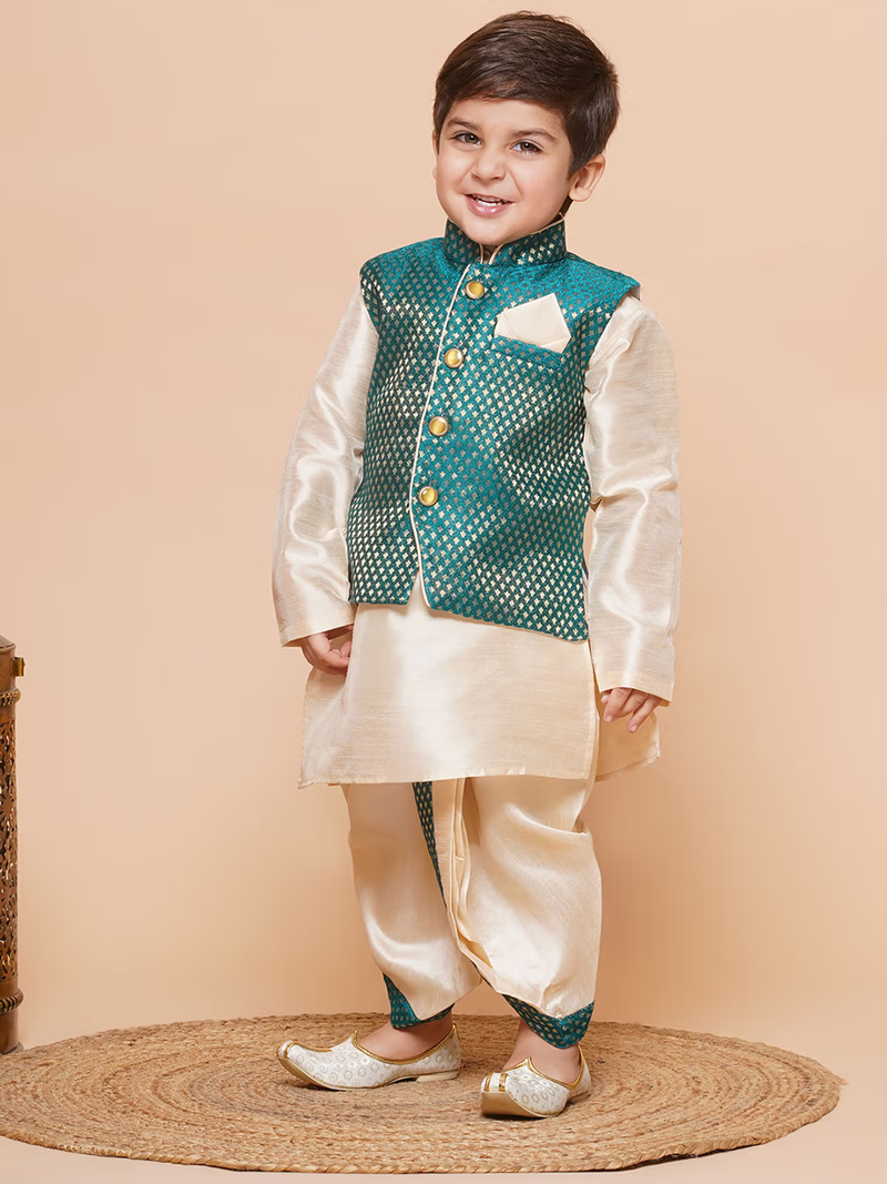 Young boy wearing boys green silk dhoti kurta set cream kurta ivory dhoti teal vest and traditional jutti