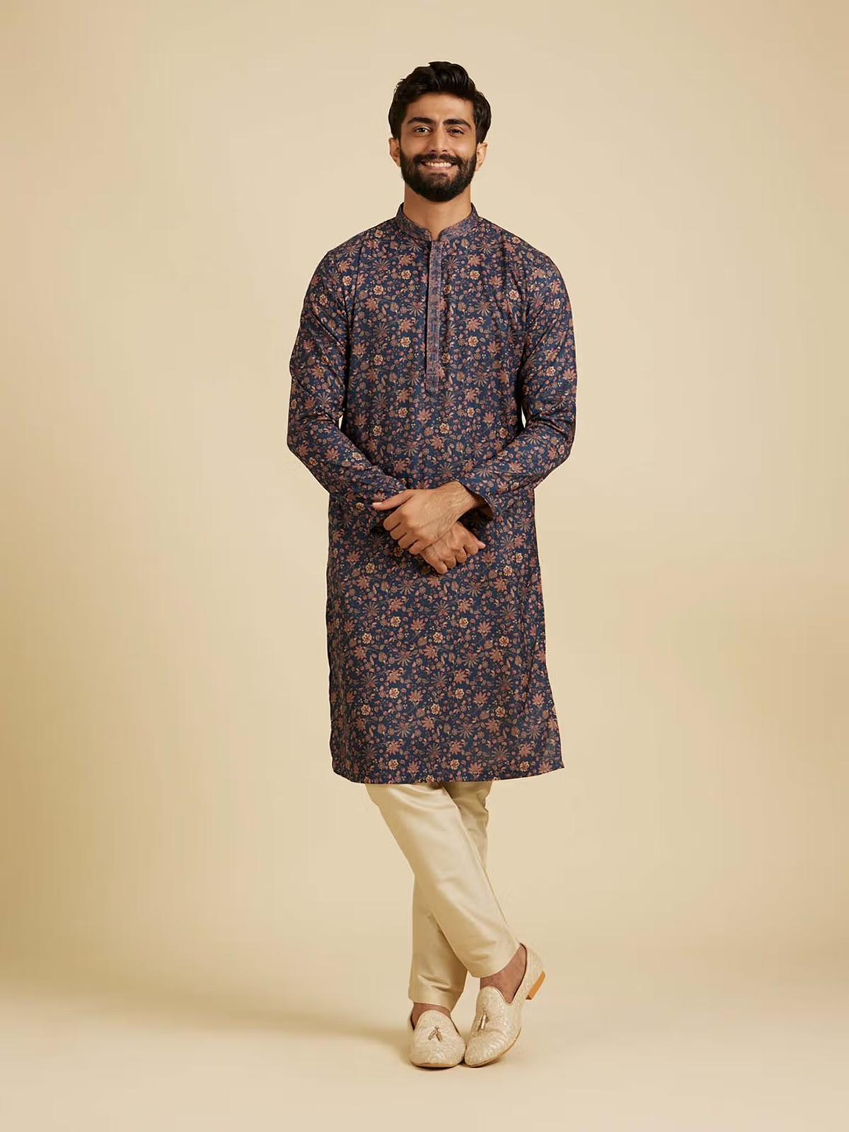 Male model wearing AROMIE blue floral kurta pyjama set with beige pyjama and traditional jutti shoes