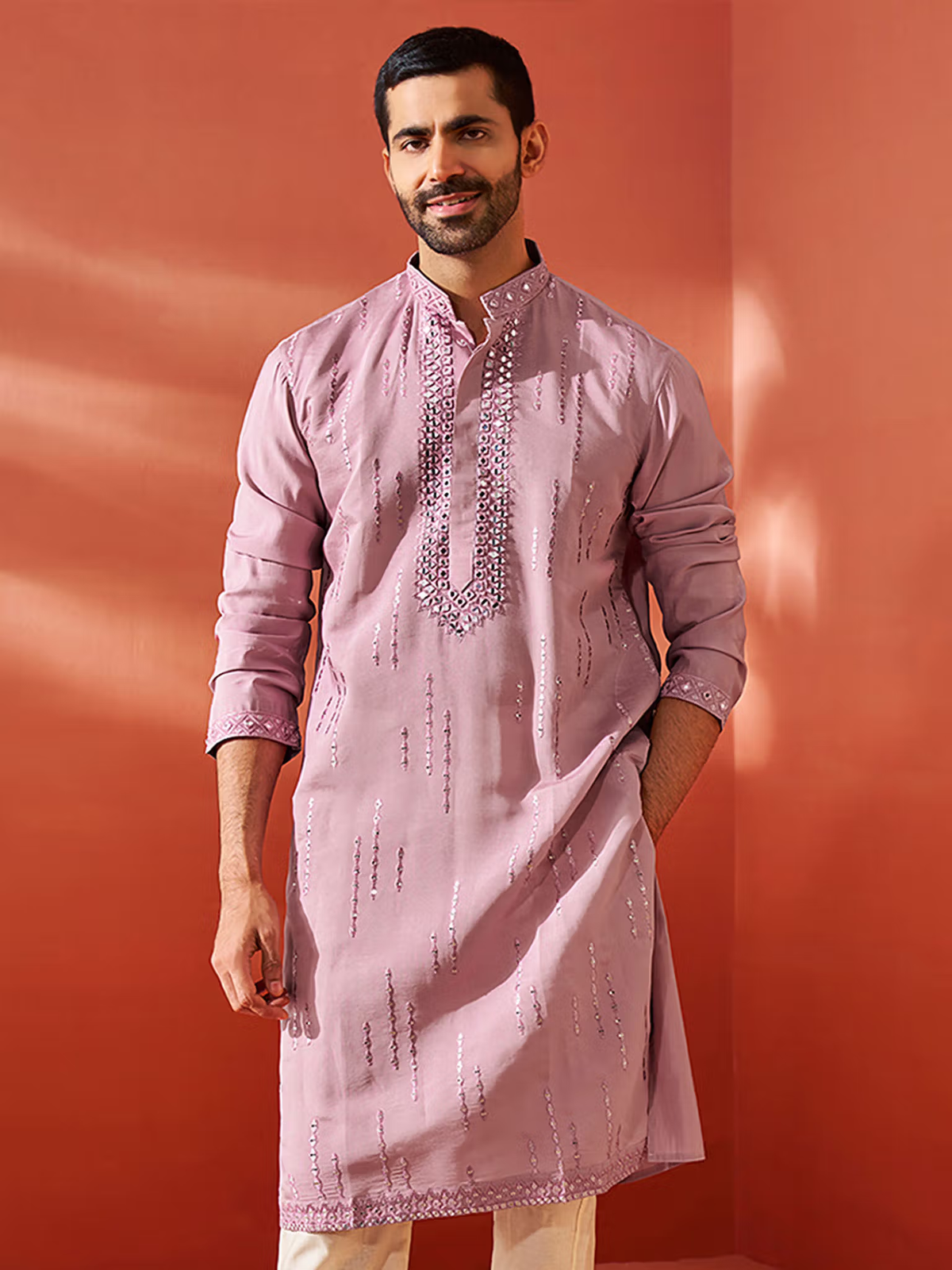 Model wearing mens chanderi silk kurta dusty pink with vertical sequin embroidery band collar and long sleeves