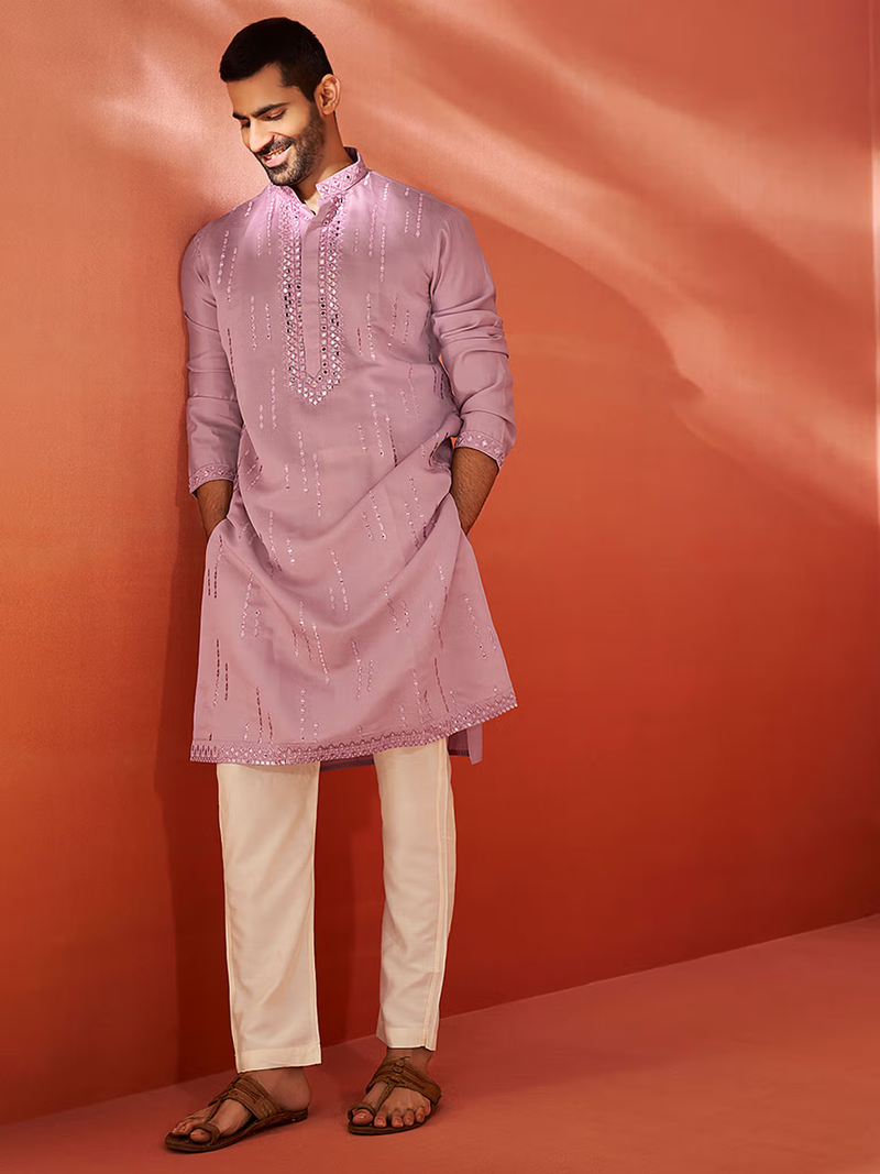 mens chanderi silk kurta light mauve embroidered kurta with beige trousers and brown sandals on smiling model