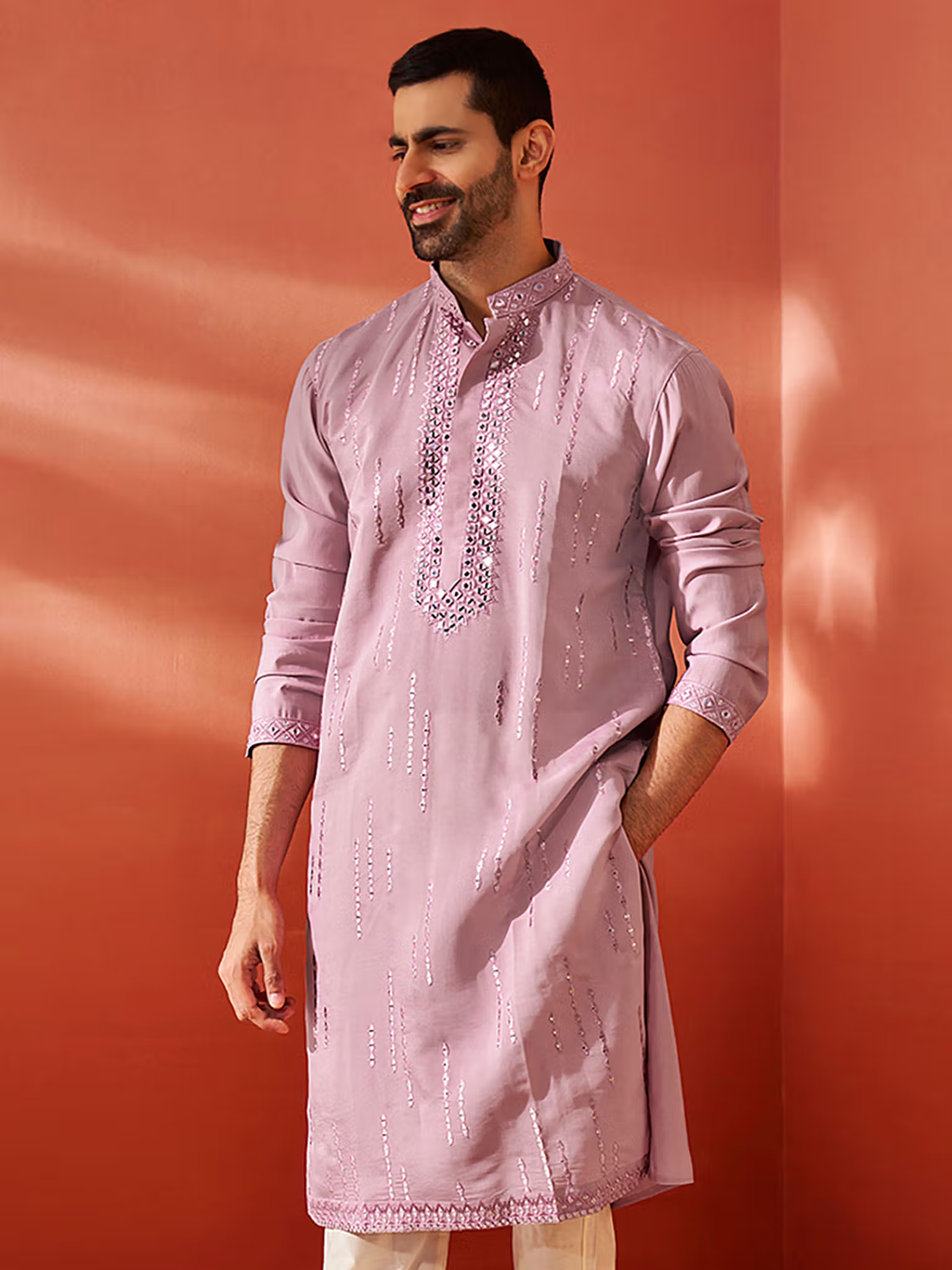 Male model wearing a lavender embroidered mens chanderi silk kurta with mandarin collar and side pockets
