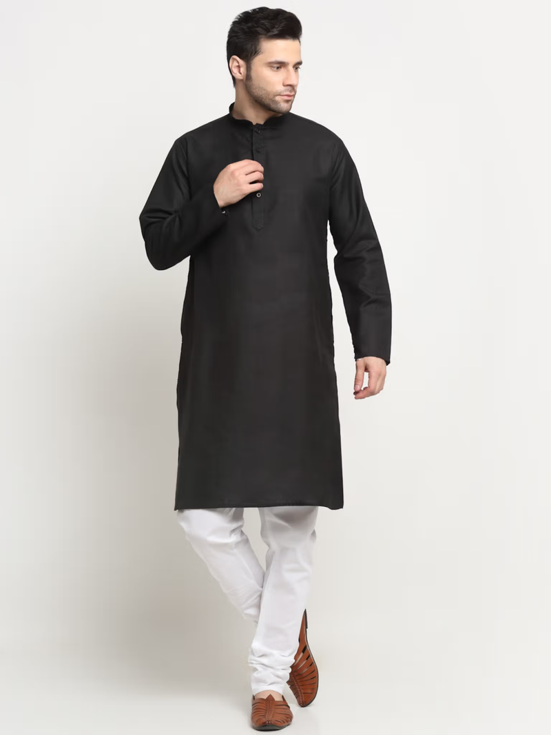 Male model wearing men's black kurta pajama nehru jacket set shown as black kurta with white pajama and brown shoes