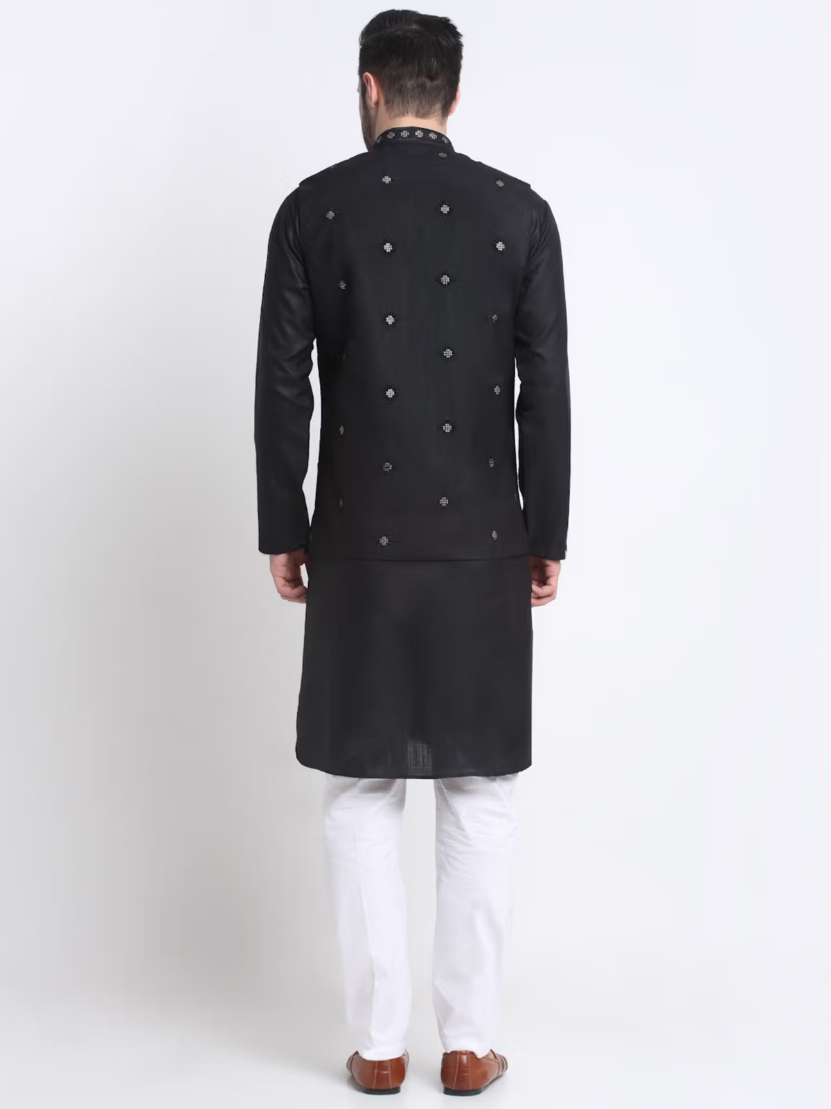 Back view of man wearing men's black kurta pajama nehru jacket set with embroidered Nehru jacket and white pajama