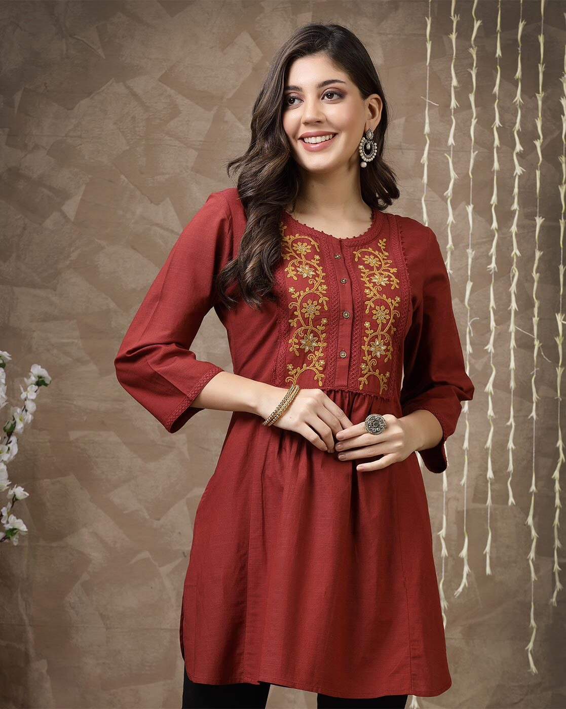 Aromie maroon embroidered tunic for women with gold floral front embroidery three quarter sleeves and gathered waist