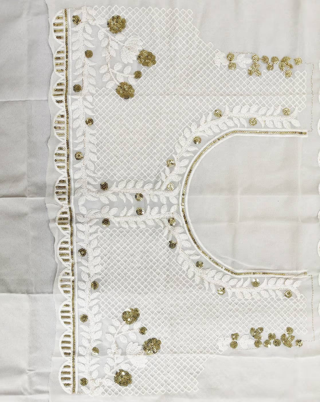 White fabric panel of women embellished lehenga choli set with gold sequin floral embroidery and lattice work