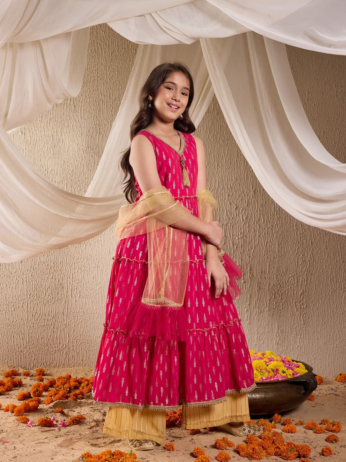 Young girl modeling fuchsia Indian kurta palazzo dupatta set Canada with golden palazzo and sheer dupatta