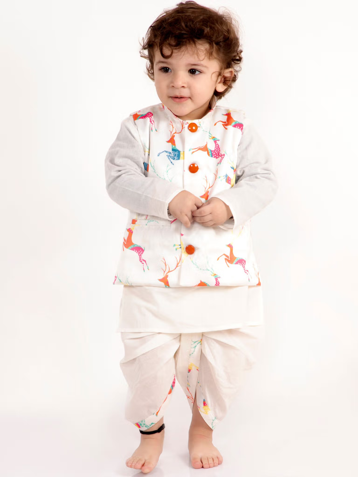Toddler wearing boys white kurta dhoti jacket set with colorful animal print jacket and orange buttons