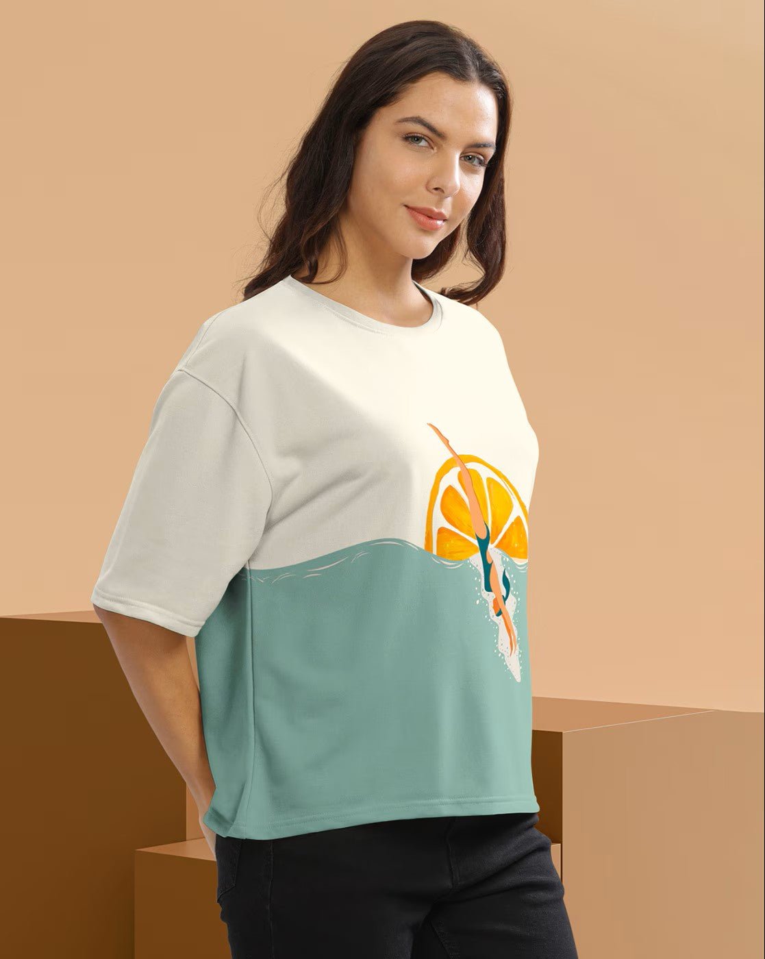 Aromie women's graphic crop t-shirt in cream and teal with orange slice design