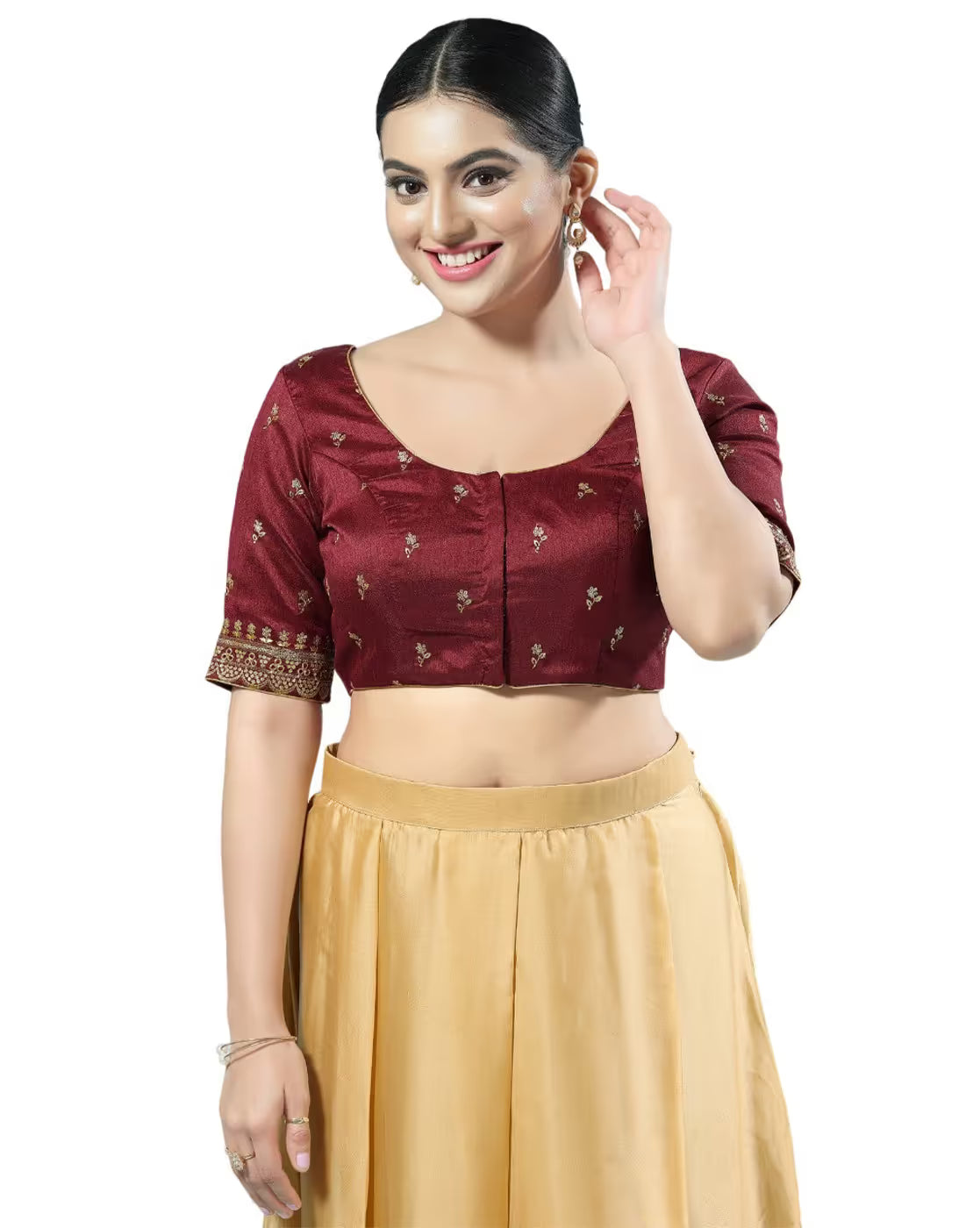 Woman wearing a maroon blouse with gold patterns and a yellow skirt on a white background