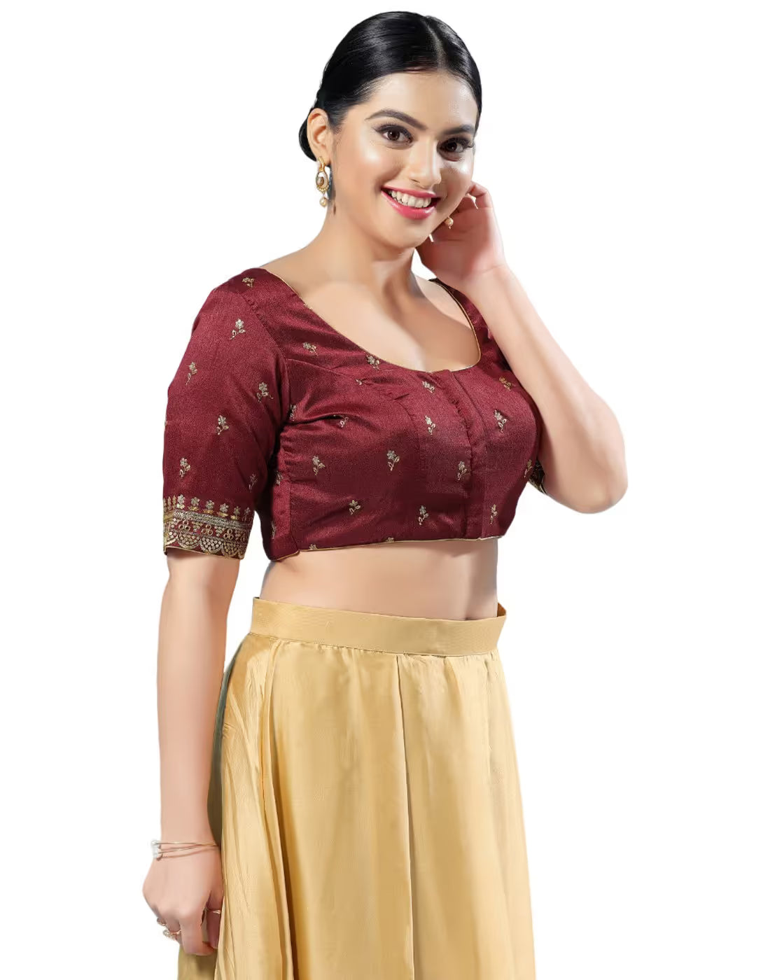Woman wearing a maroon blouse with gold patterns and a beige skirt on a white background