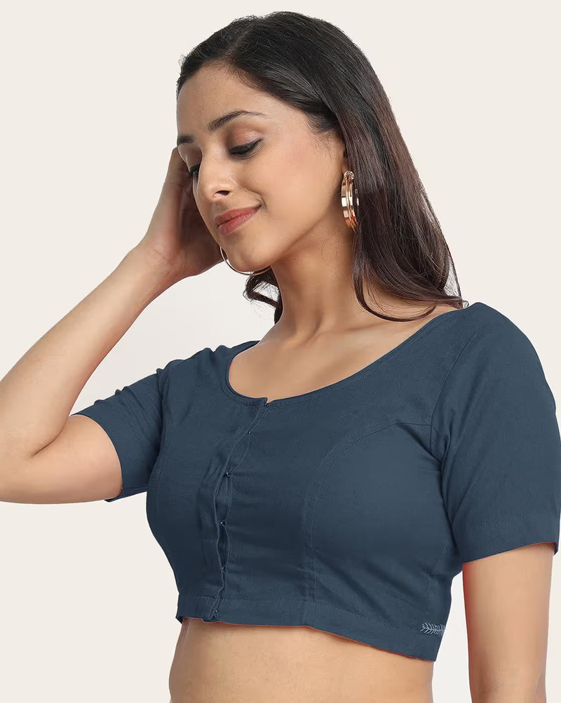 Woman wearing a blue blouse against a plain background