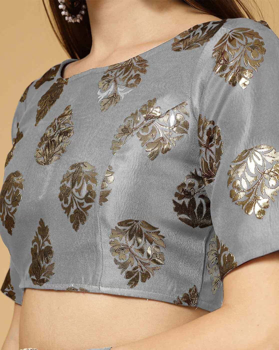 Gray blouse with gold leaf patterns on a beige background