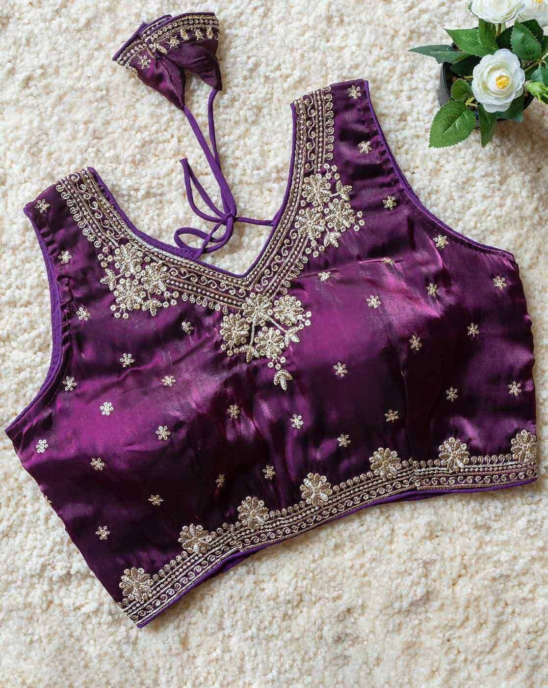 Purple blouse with silver embroidery on a textured surface