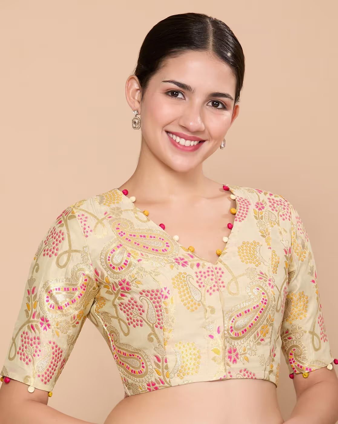 Woman wearing a patterned blouse with a beige background