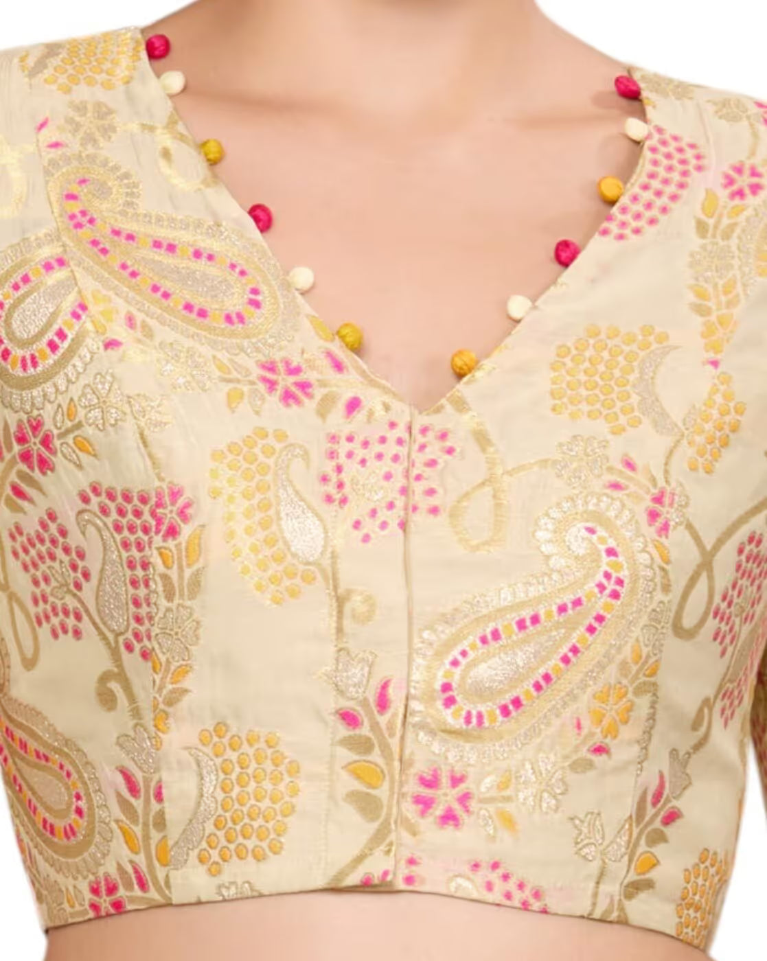 Beige blouse with floral and paisley patterns and colorful embellishments.