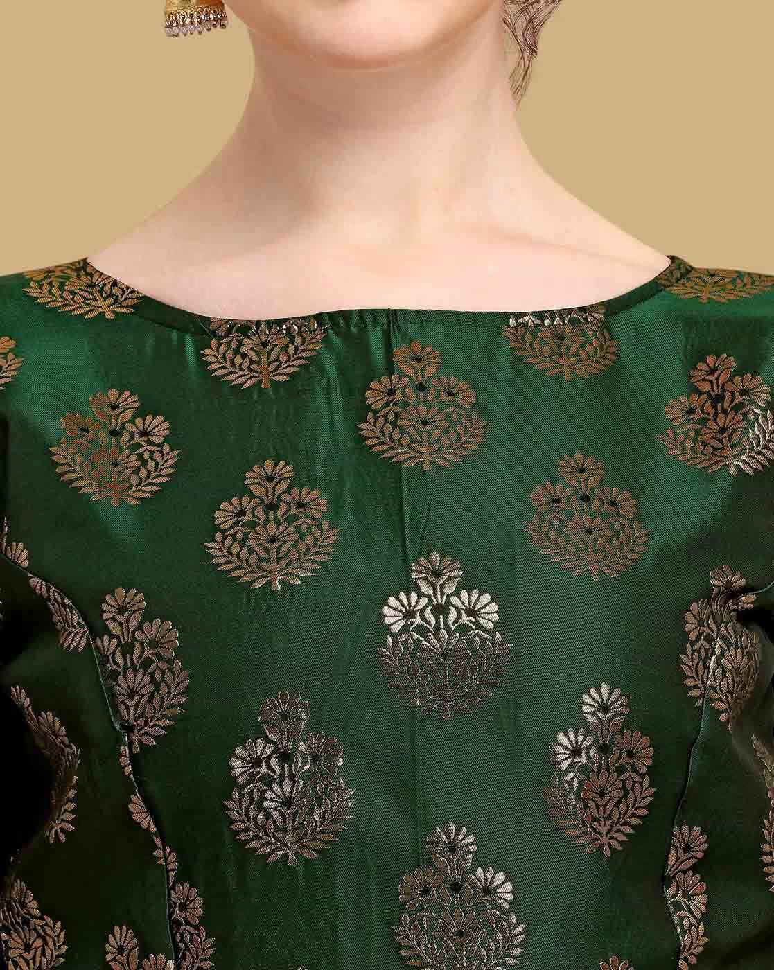 Green fabric with intricate gold patterns on a plain background