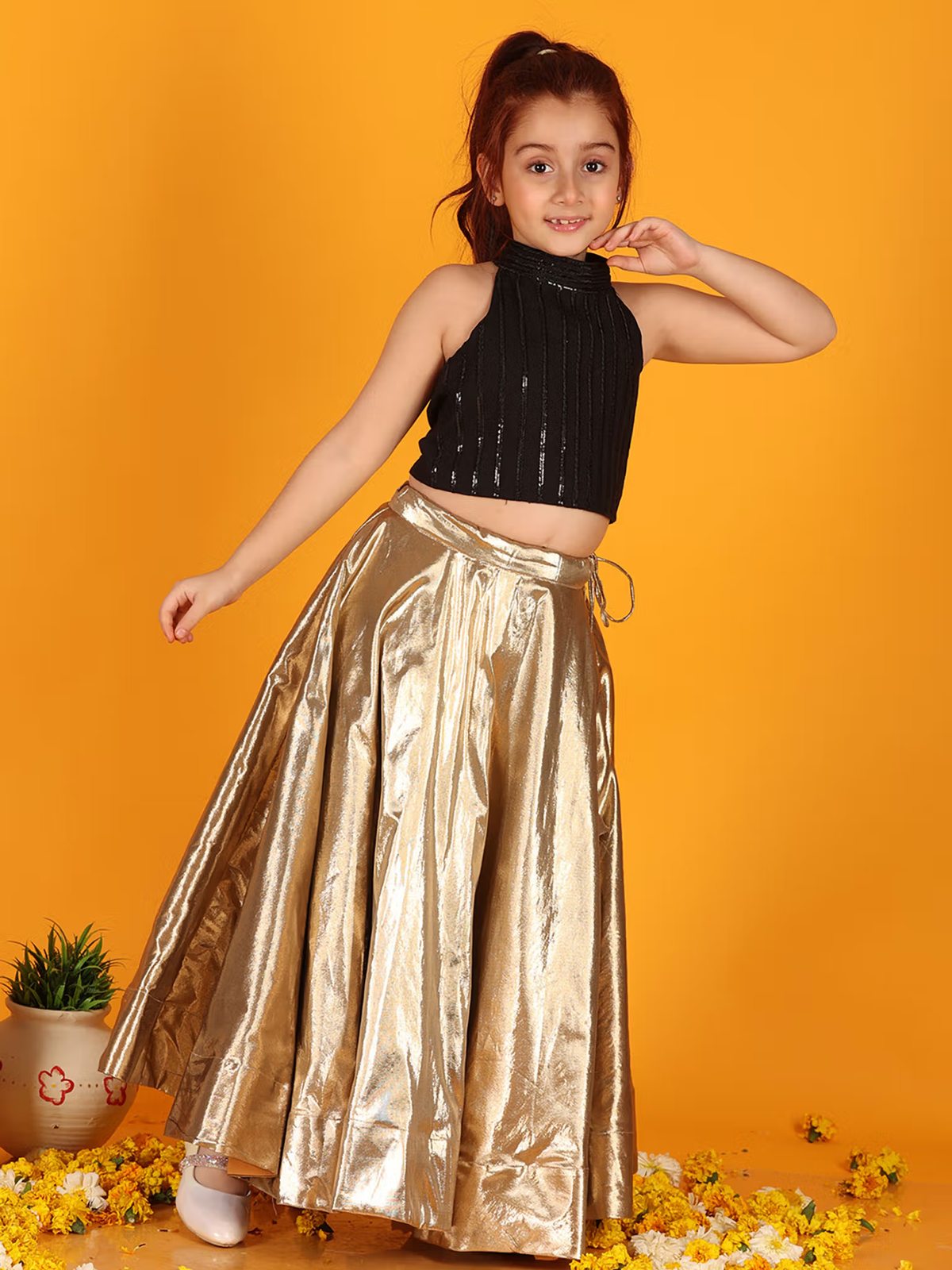 Aromie girls model wearing a black sequin high neck top with metallic gold flared skirt Girls Anarkali Kurta Set