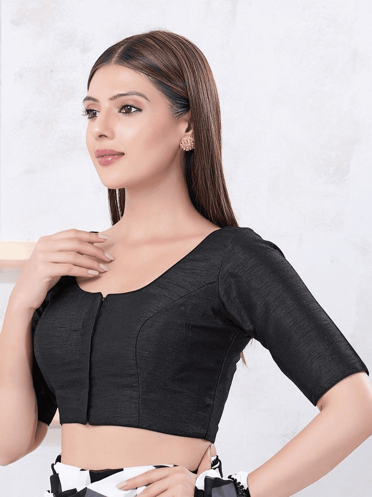 Woman wearing a black blouse against a white background