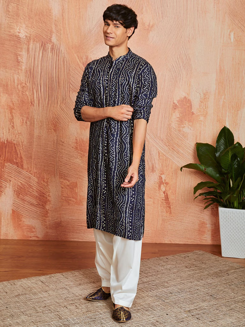 Male model wearing navy bandhani kurta with white churidar and jutti shoes Men's Bandhani kurta set Canada
