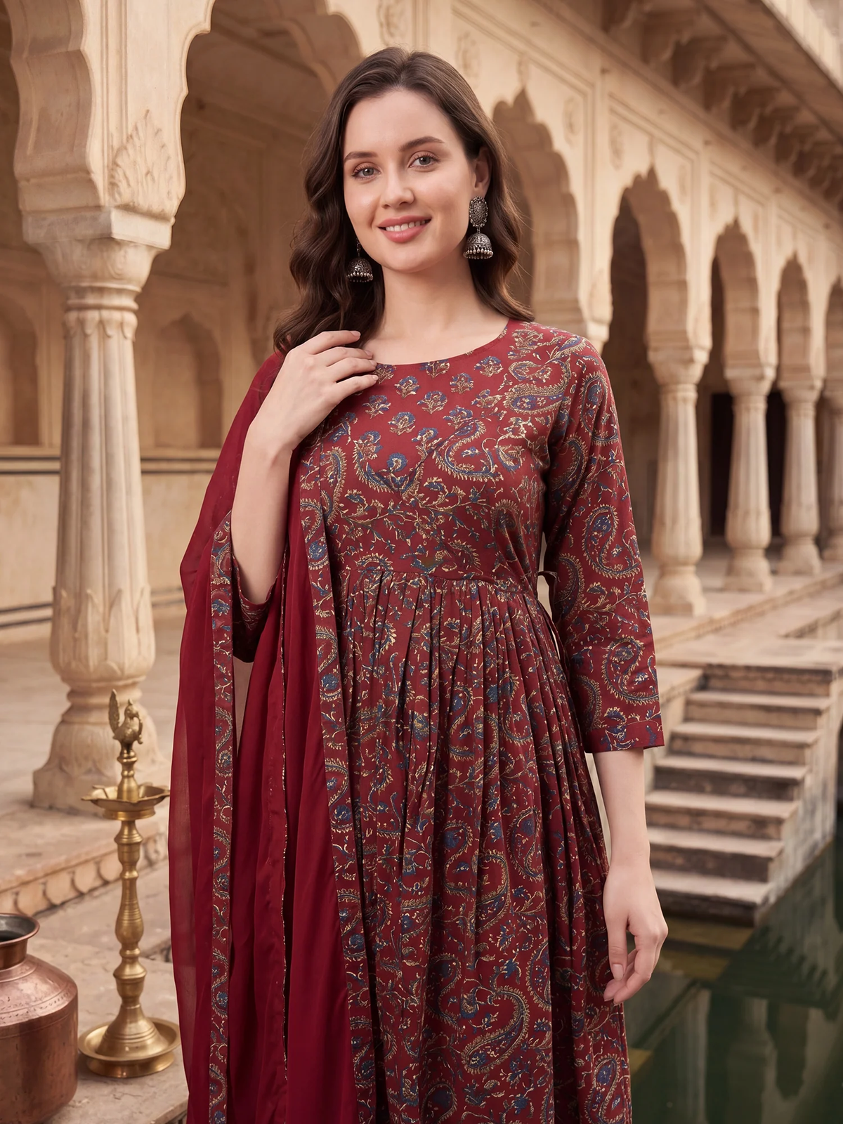 Woman in a red patterned dress standing in an architectural setting
