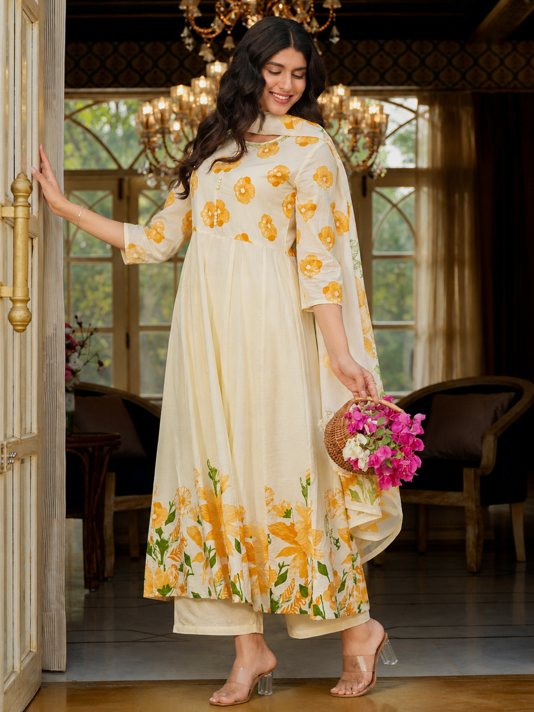 Woman in a floral dress holding flowers in a decorated room