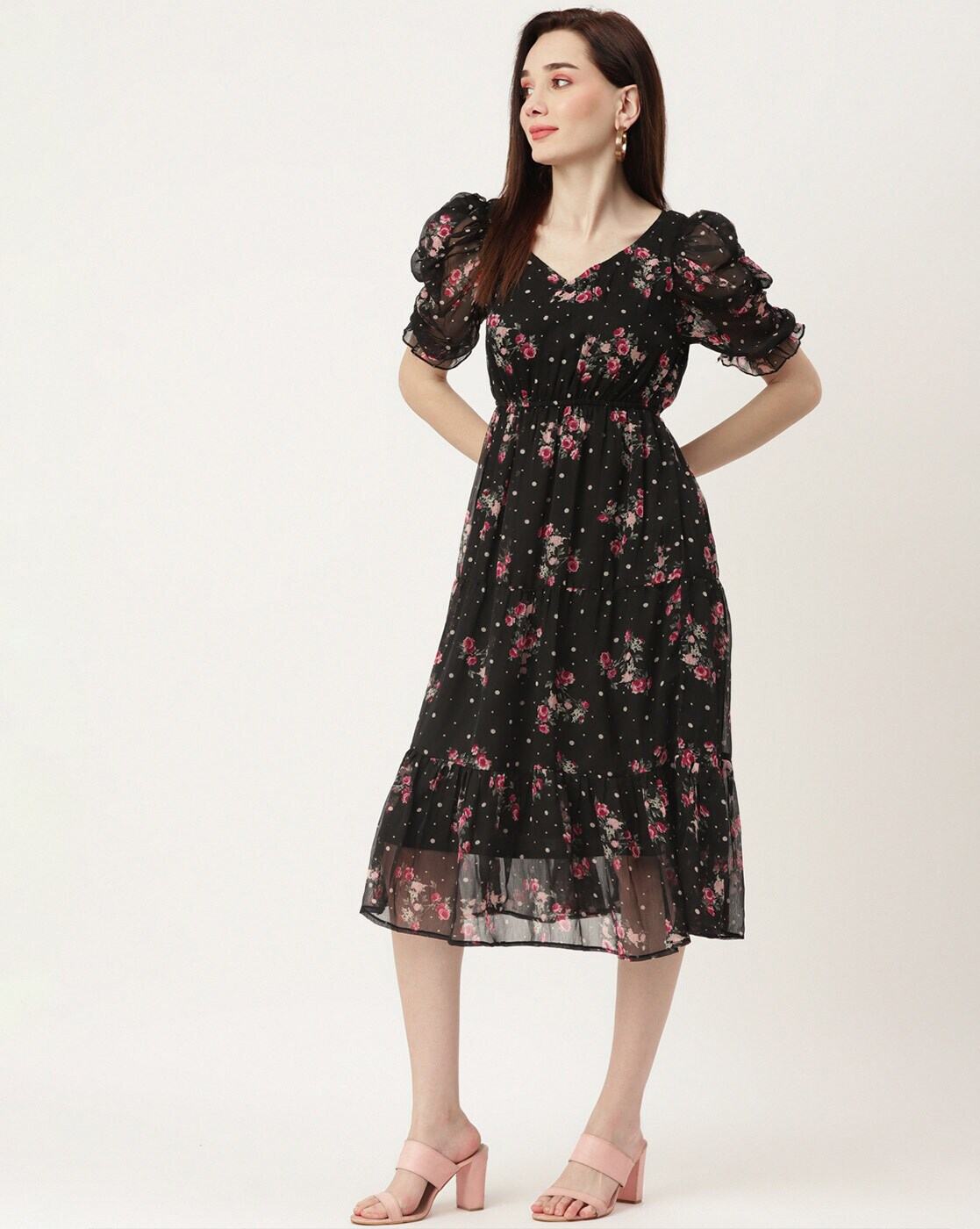 Woman wearing a black floral georgette wrap dress with puff sleeves and V-neck – lined fit & flare style for casual or party wear.