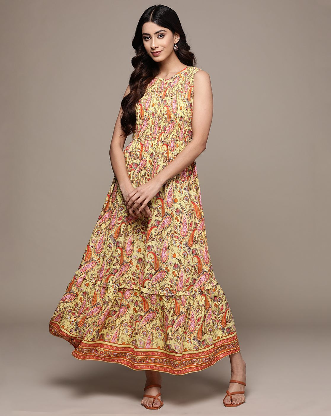 Woman wearing a paisley print sleeveless fit & flare rayon dress with round neckline – classic and lightweight casual wear.