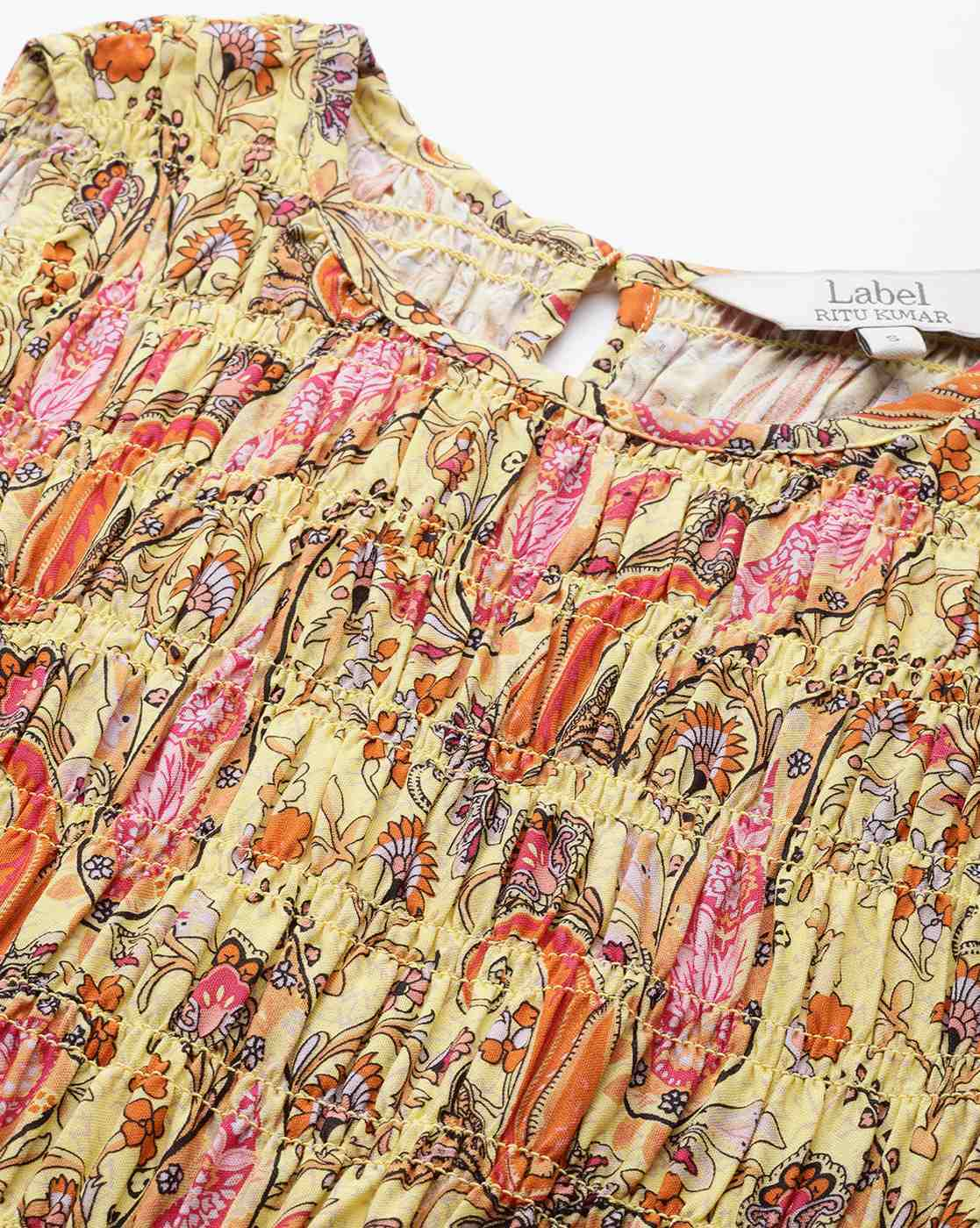 Woman wearing a paisley print sleeveless fit & flare rayon dress with round neckline – classic and lightweight casual wear.