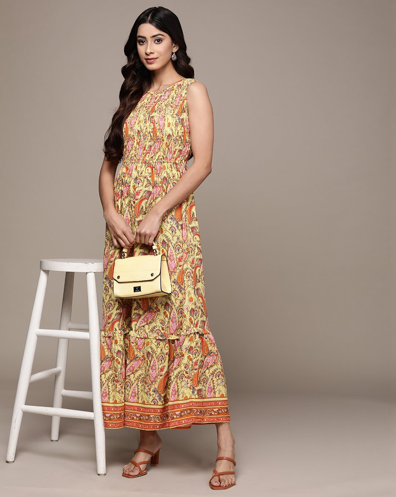 Woman wearing a paisley print sleeveless fit & flare rayon dress with round neckline – classic and lightweight casual wear.
