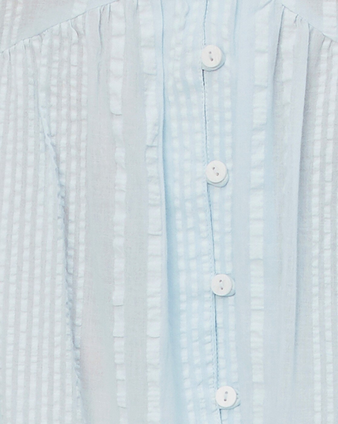Woman wearing a 100% cotton seersucker tiered dress with round neckline – casual and lightweight for everyday summer wear.