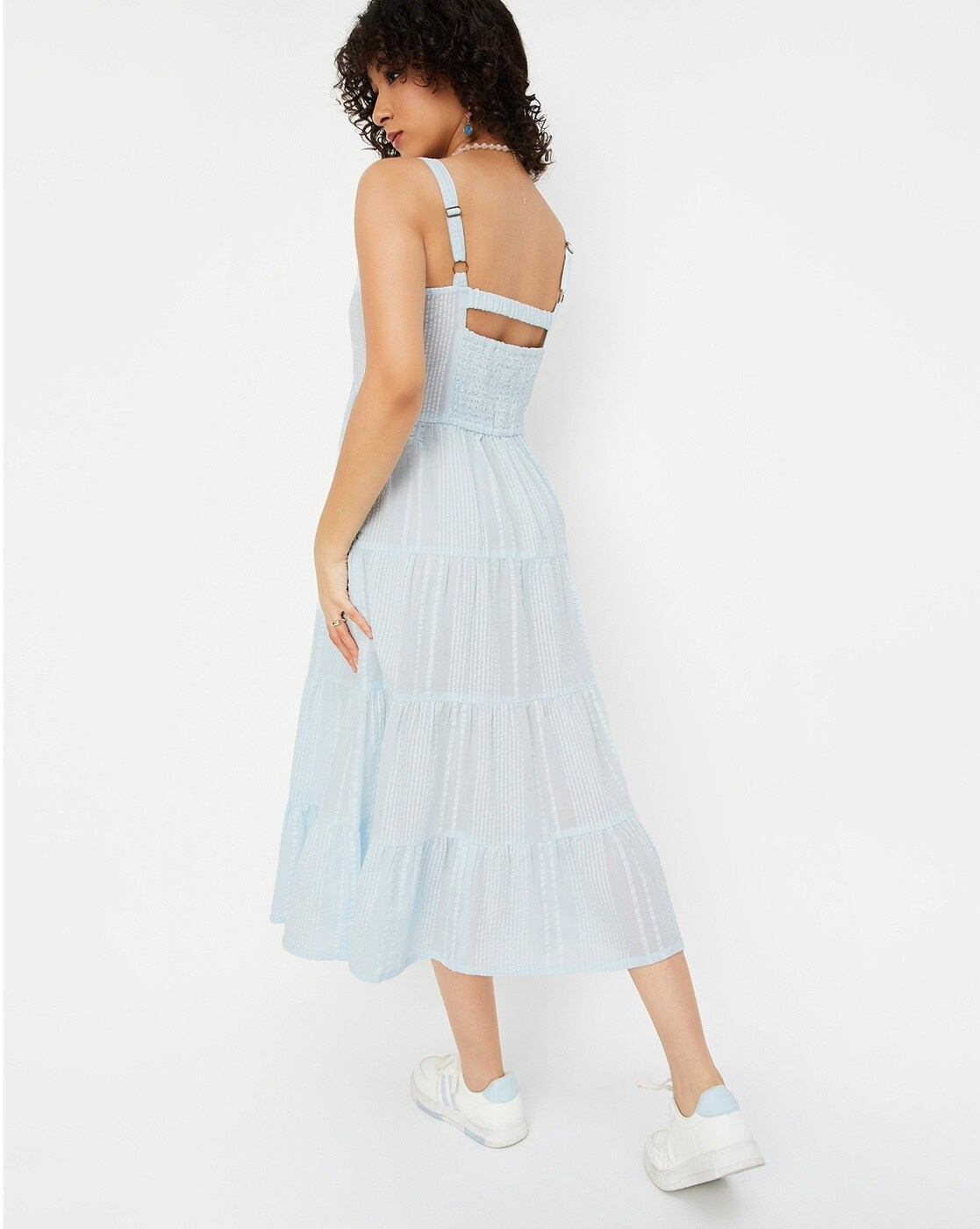 Woman wearing a 100% cotton seersucker tiered dress with round neckline – casual and lightweight for everyday summer wear.