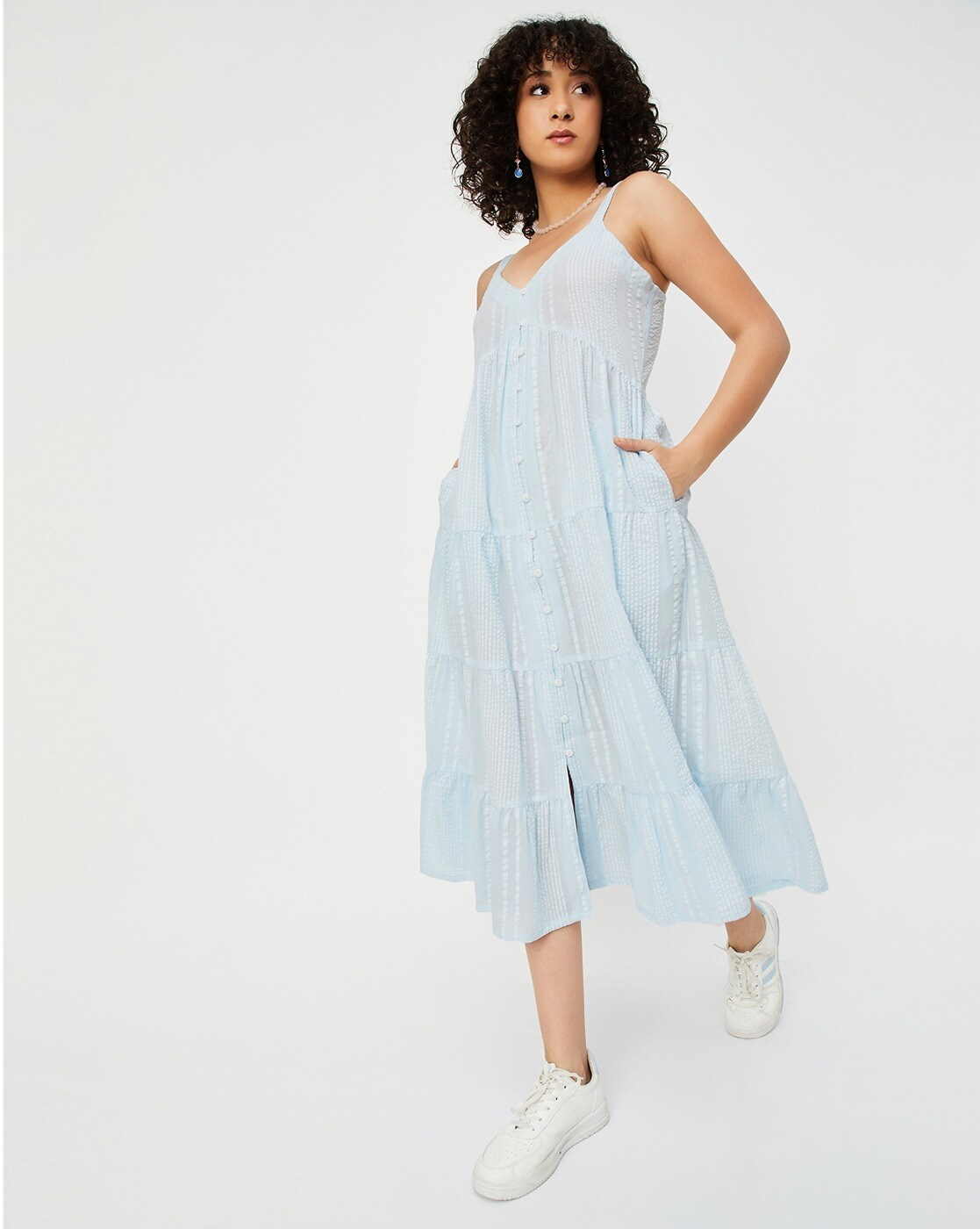 Woman wearing a 100% cotton seersucker tiered dress with round neckline – casual and lightweight for everyday summer wear.