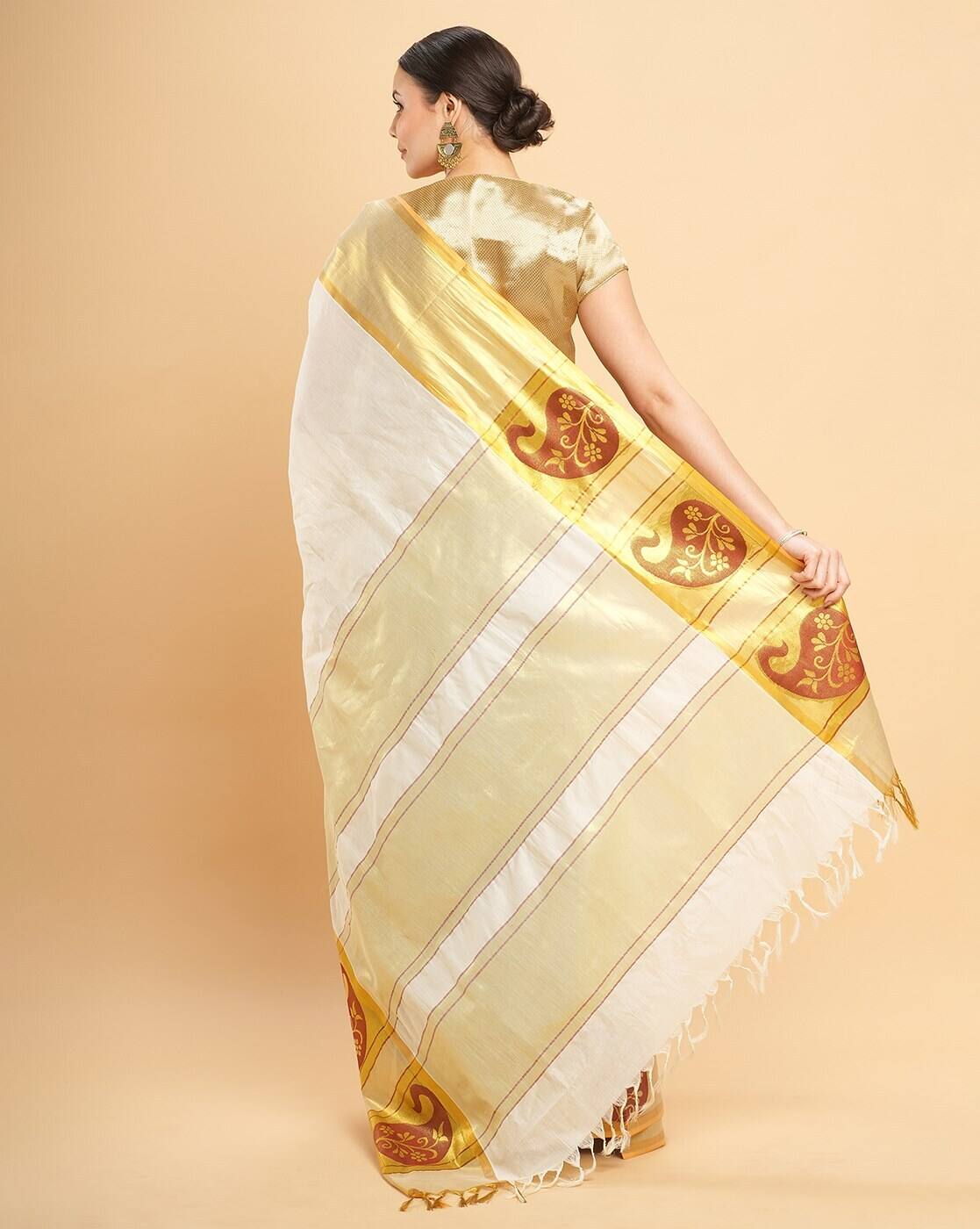 Aromie affordable embellished saree in white and gold worn by a model showing back design