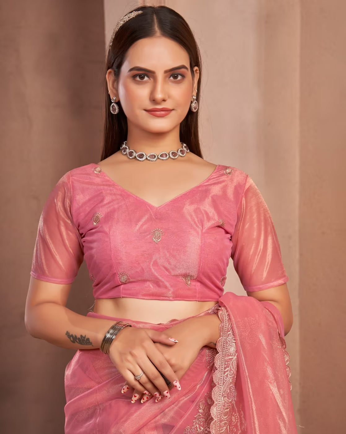 Elegant model wearing an affordable embellished saree in pink with matching blouse and jewelry