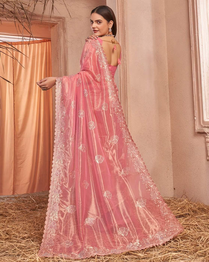 Model wearing an affordable embellished saree in pink with intricate floral designs and a flowing drape
