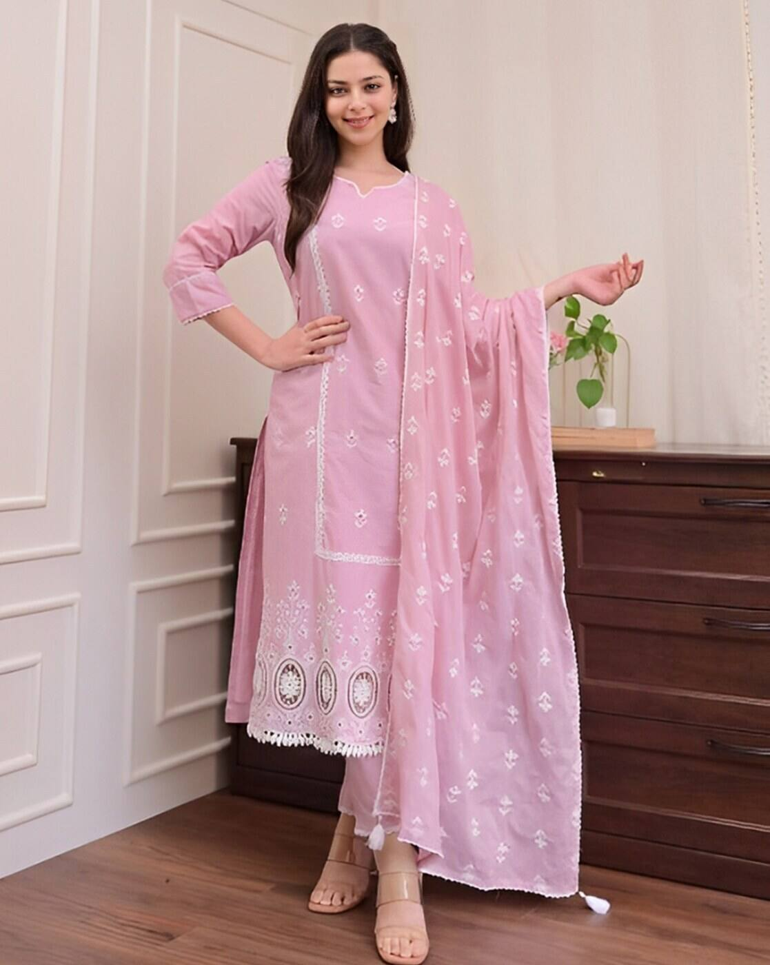 Aromie three piece kurtha in pink with white embroidery worn by a woman affordable kurta suit set