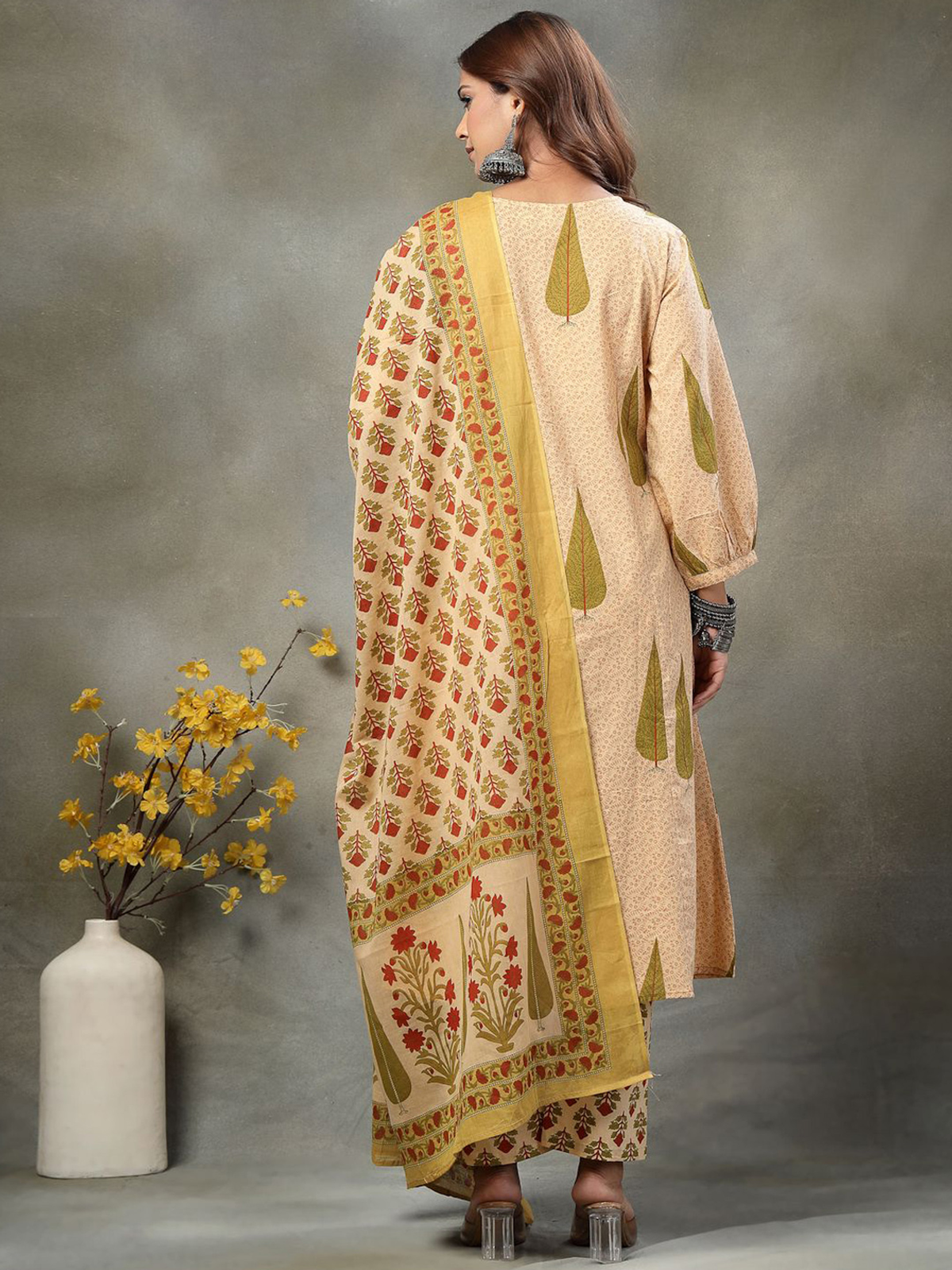 Beige Anarkali kurta set with palazzo and floral dupatta, perfect for weddings or festive occasions