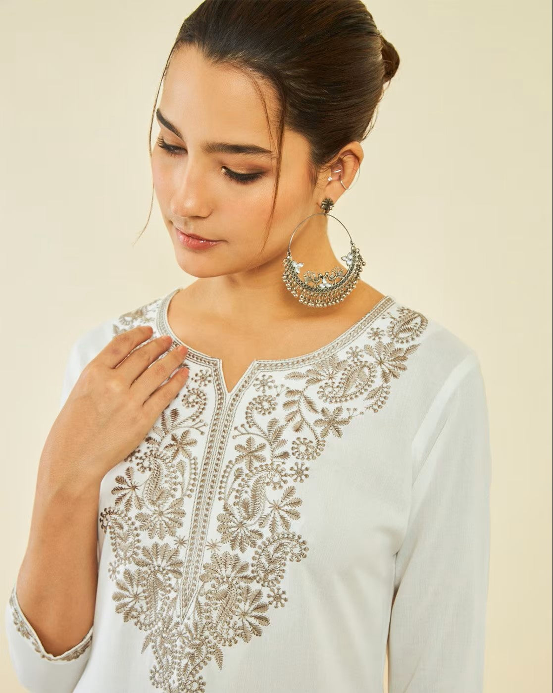 aromie sleeveless cotton peplum top listing photo showing model wearing white embroidered long sleeve top