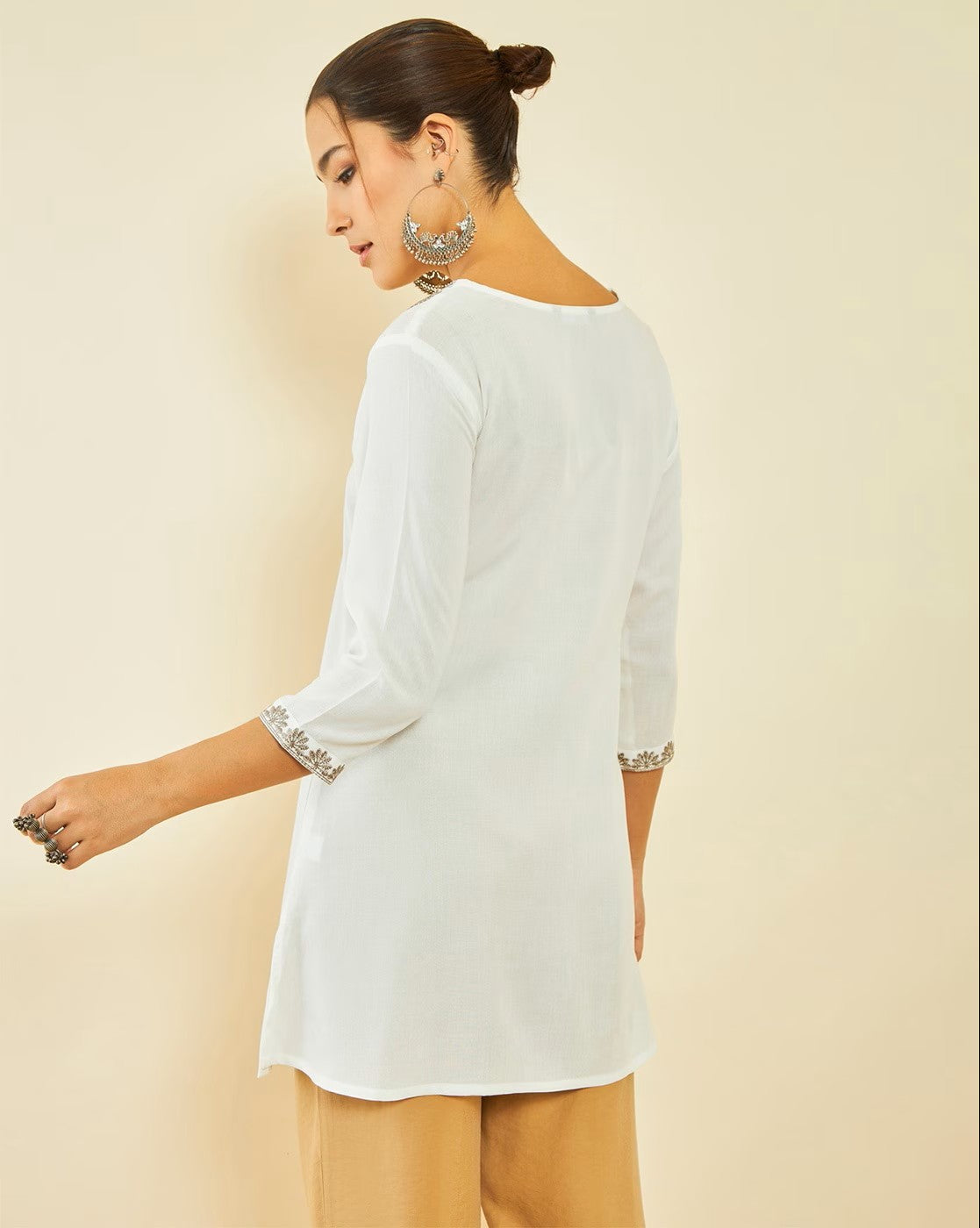 aromie sleeveless cotton peplum top styled under a white three quarter sleeve tunic back view